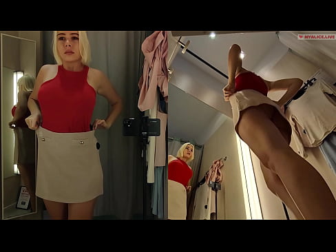 Blonde with big boobs tries on transparent clothes. Video from public dressing room