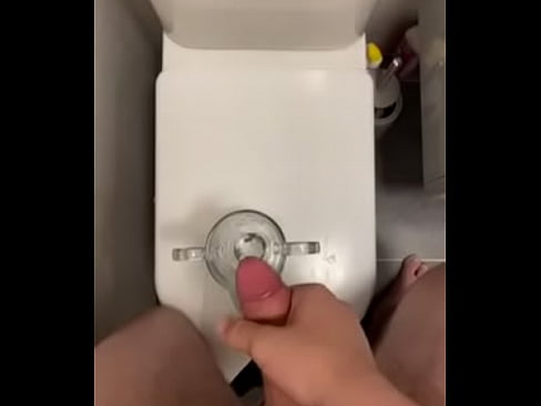 Guy cums into a glass for a tasty treat