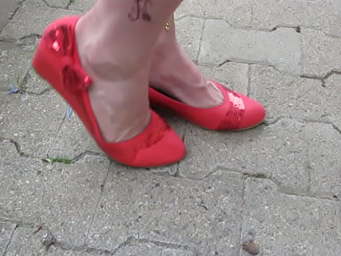 French Queen of shoeplay shows her red leather pumps