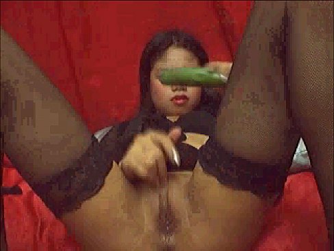 Angel asian taking cucumber