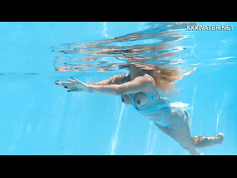 Her body cutting through the shimmering water of the pool