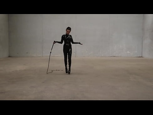 Trans Goddess Obsidian show of her bullwhip ing skills as she struts around in her latex catsuit.