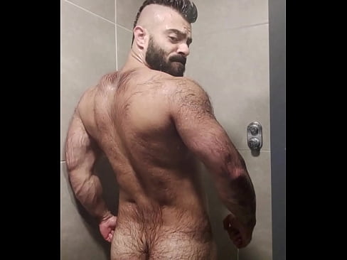 Furry sweat bear taking a shower after training.