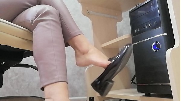 MILF teases with foots and shoes during work.