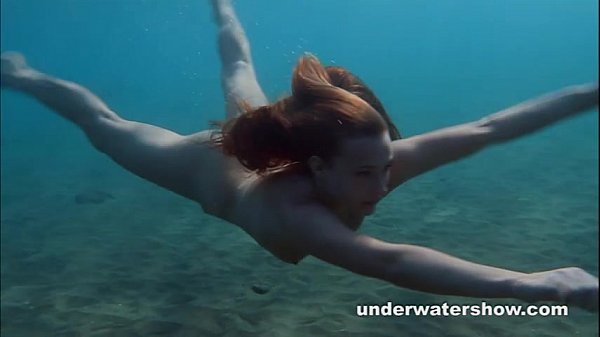 Julia is swimming underwater nude in the sea