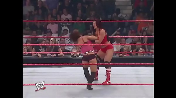 Mickie James faces her opponent while they both wear revealing outfits.