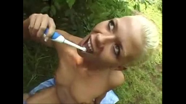 Brushing her teeth outdoors with his cum