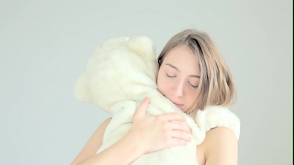 Hot naked blonde cuddling her teddy bear