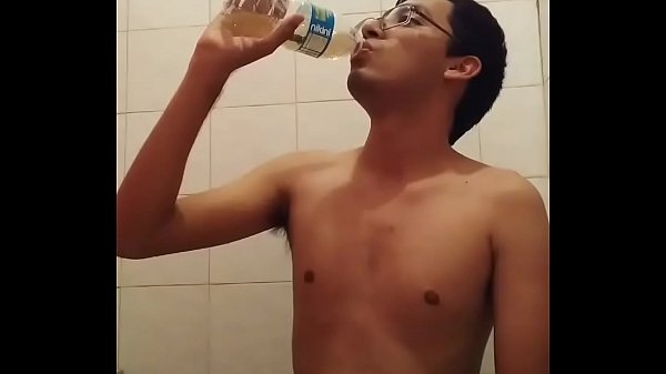 Boy pisses in bottle and gulps it down