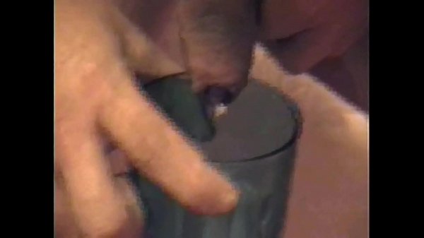 masked bisexual squirts milk in a glass