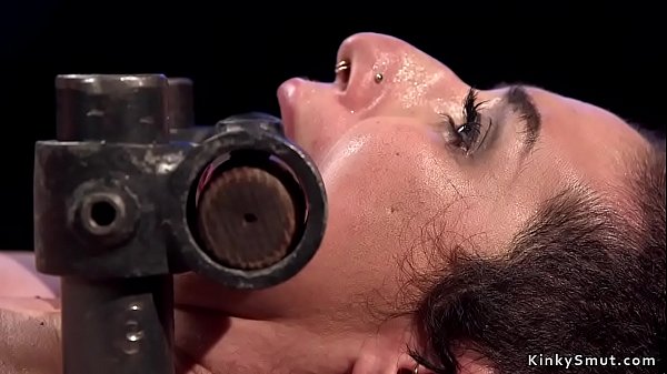 Natural busty slut in metal device bondage gets throat gagged