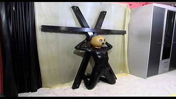 A slut with a sinister mask is crucified and punished by her master