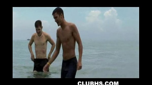 Two hunks play on the beach before jerking off