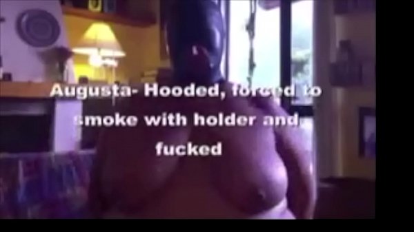 Augusta- A slut wife is chairbound, hooded, smoking with a long holder, then gagged and fucked