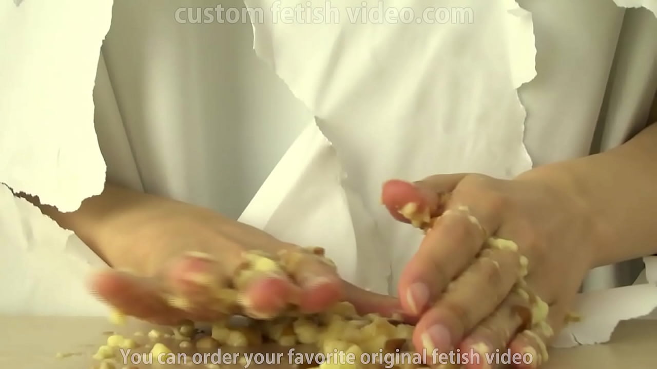 Fetish of a woman's hand coming out and crushing the pudding.