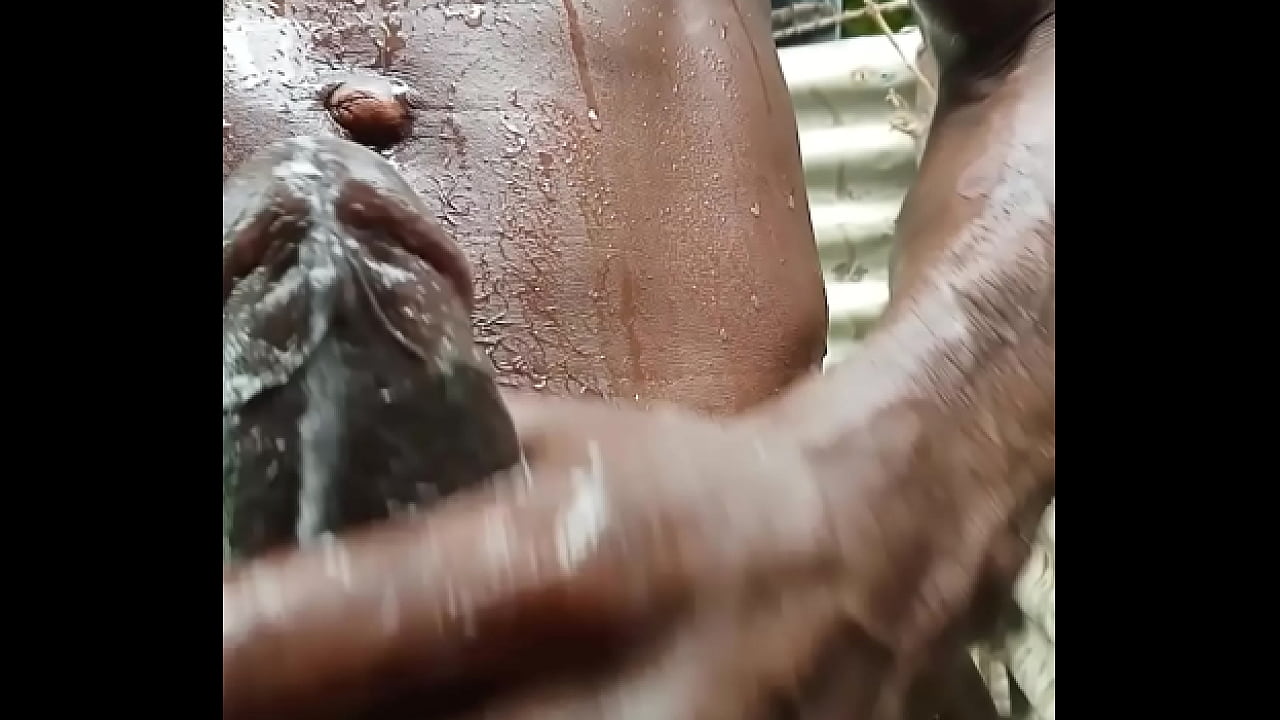 Village boy playing with his BBC in the shower