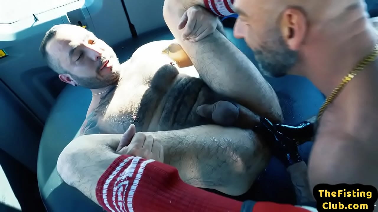 Hairy hunk getting fisted by inked partner in the trunk