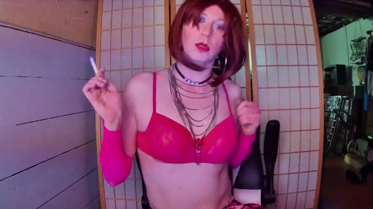 Redhead transvestite hooker Adrienne Velvet in pink bra smoking fetish