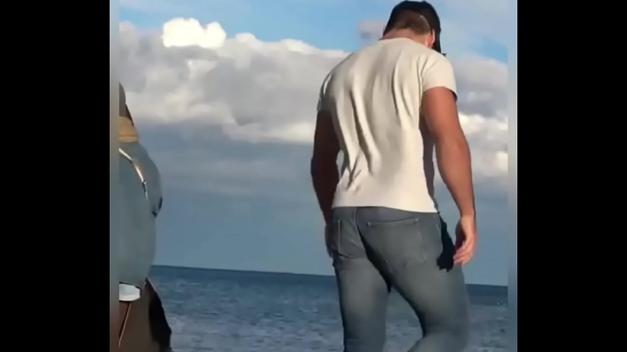 Tight wet jeans hunk walks into the sea