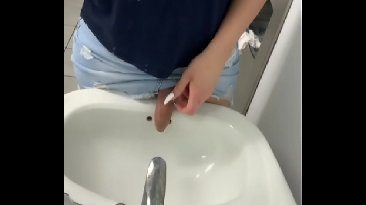 Transsexual peeing in public bathroom