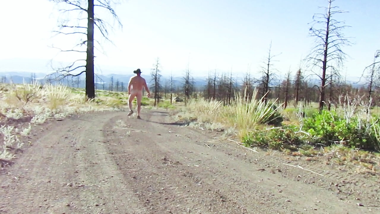 Naked walk on a dirt road.