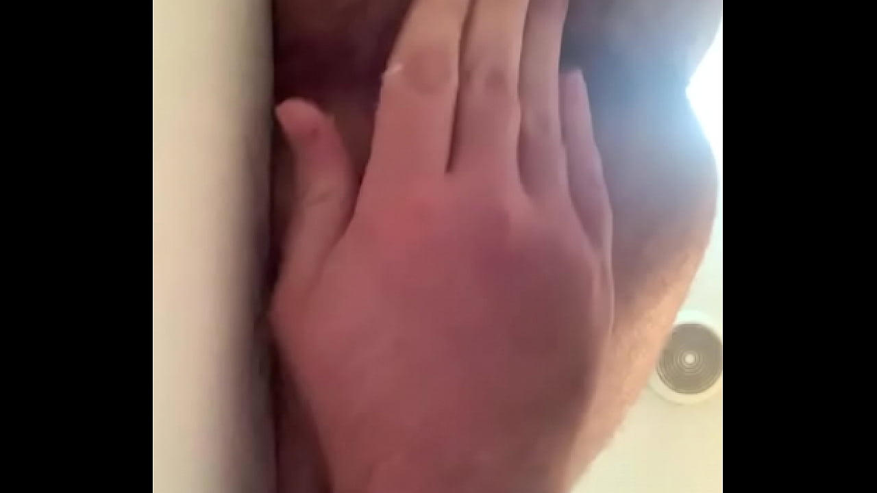 horny young man plays by shower