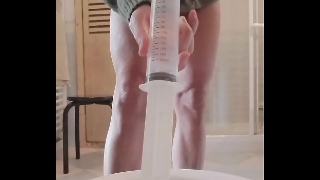 Anal enema with a big syringe.