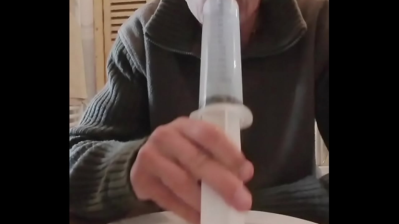 Anal enema with a big syringe.