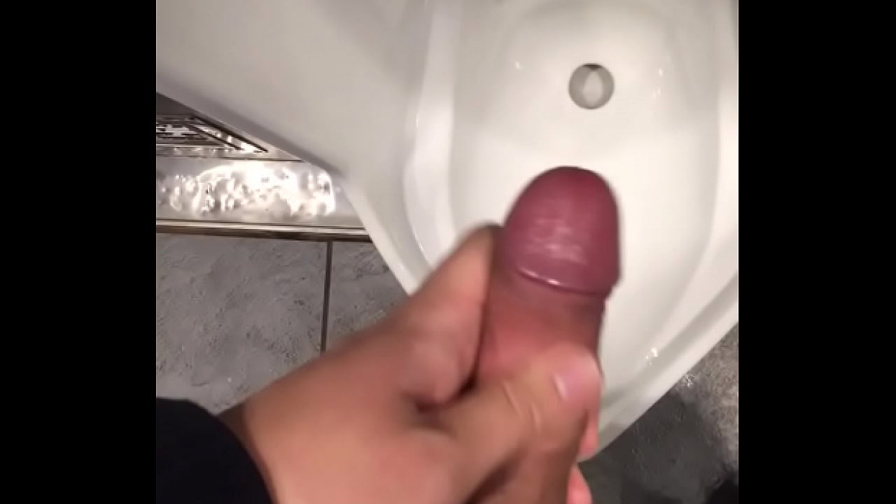 Jerking off at a urinal in the bathroom of a station