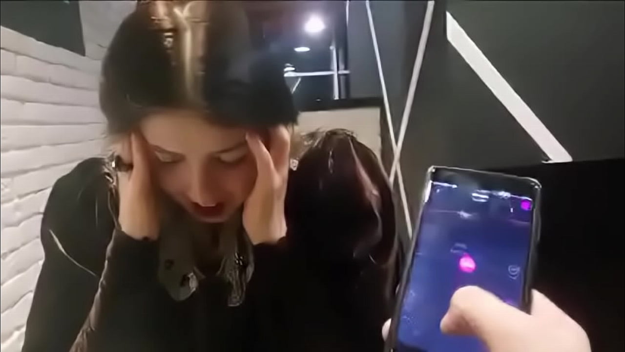 cute girl with remote vibrator in public