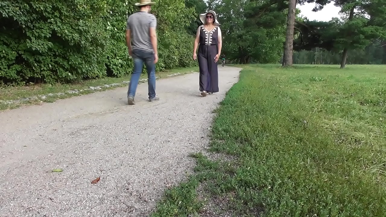 Chubby woman in transparent dress in public park