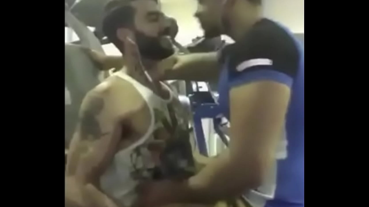 A couple of hot guys from India kissing each other passionately inside a gym