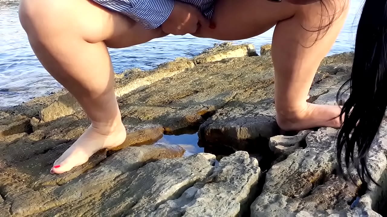 Wife pees outdoor on the beach