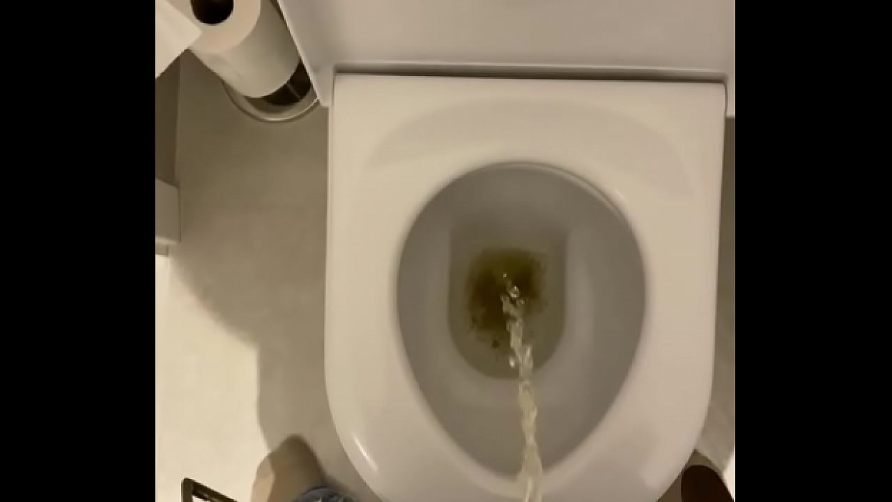 Uncut cock taking a piss into the toilet