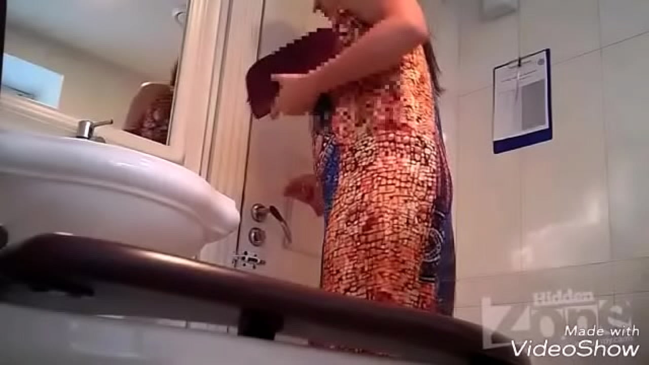 Woman in Colorful Dress Pisses in Sink