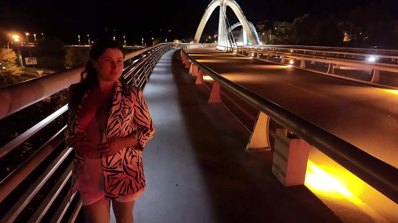 Luscious Milf walks without a Bra and Panties on the Bridge