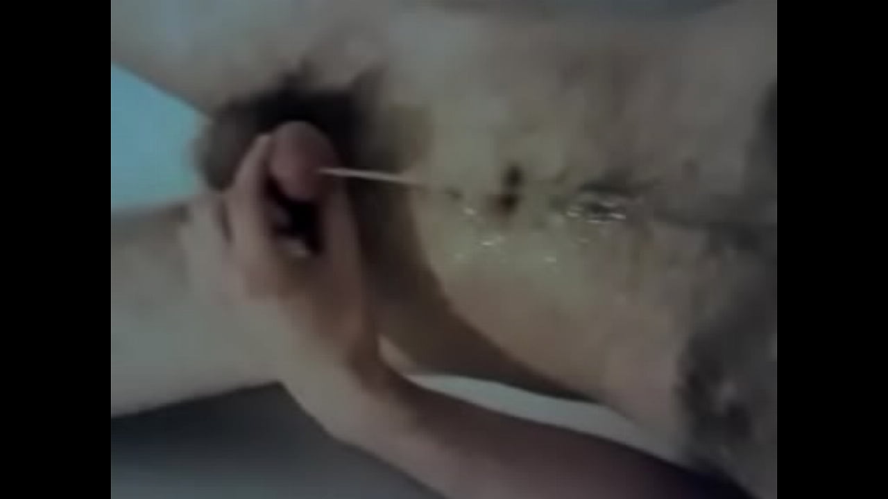 Hairy young man pissing on himself