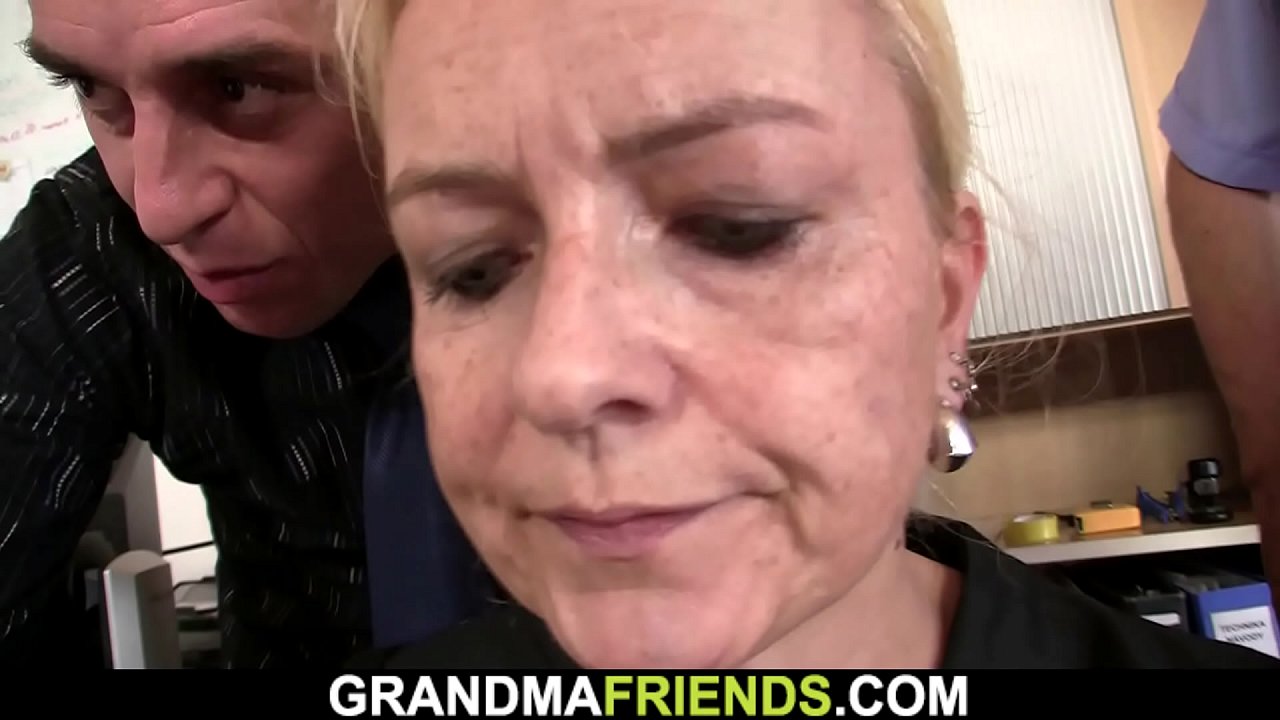 Skinny old blonde sucks two cocks at once