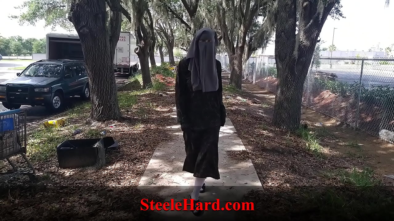 Muslim female in a niqab goes for a walk and flashes her body
