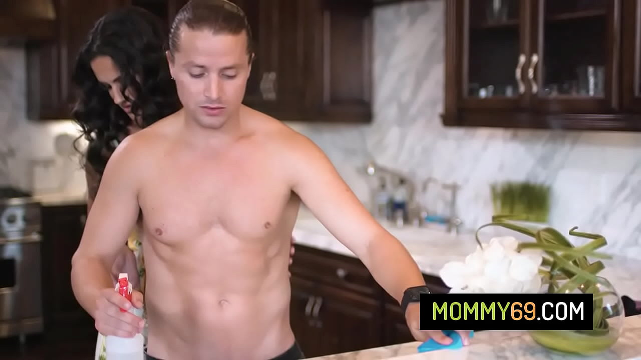 Busty stepmother fucks with her stepson in the kitchen while her bestie watches