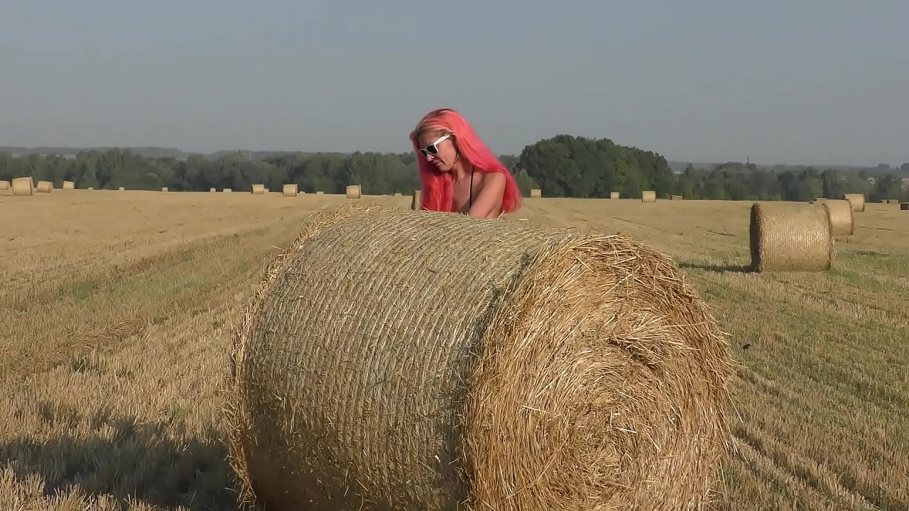 Bikini, hay rolls and field