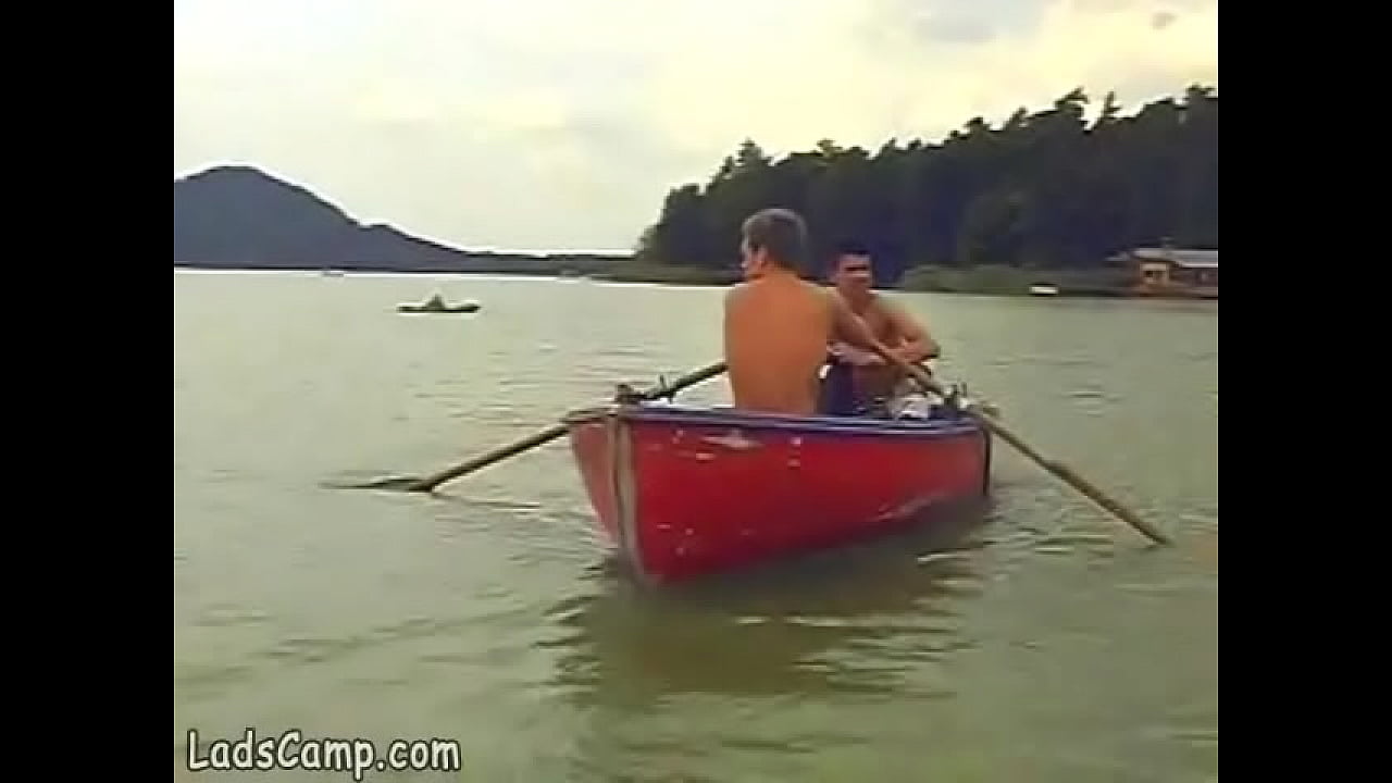 Hot boys rowing in a boat and sucking