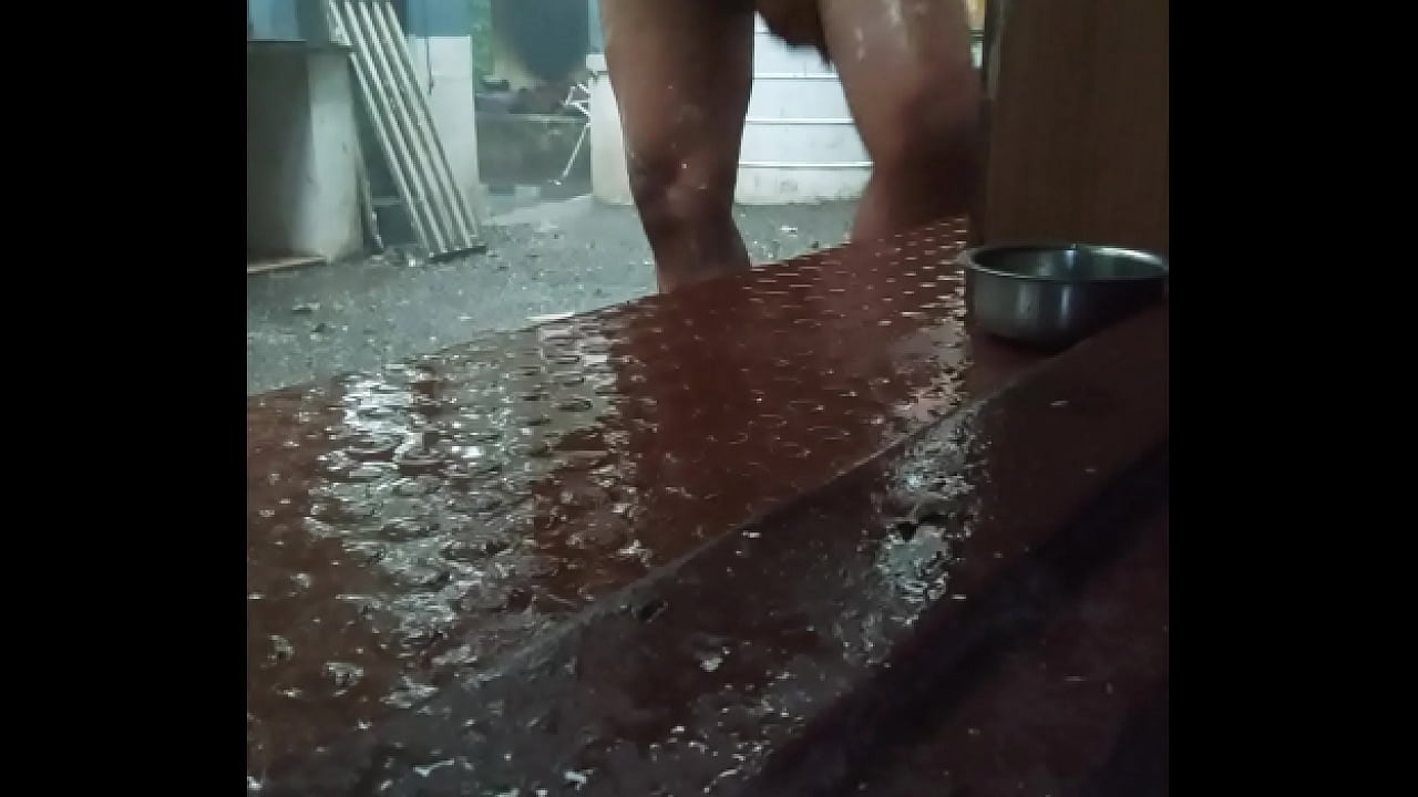 Naked indian boy taking shower in rain