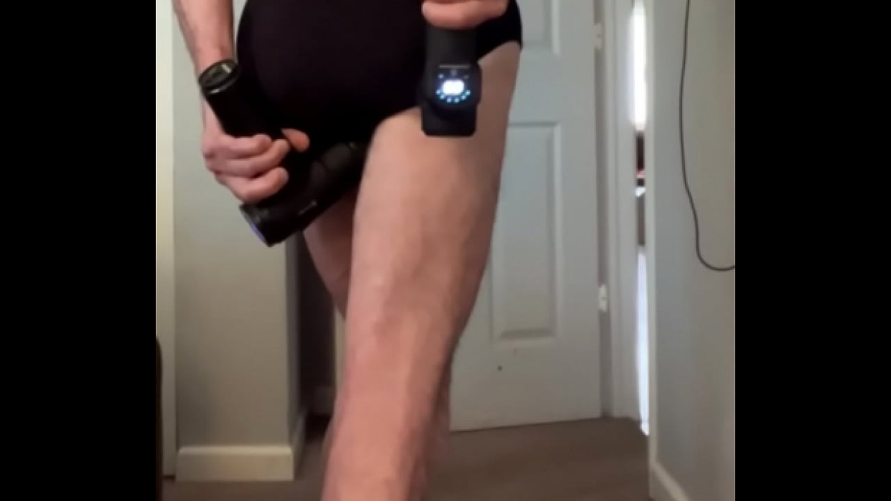 Standing Stretch in tight underwear with 2 massage guns