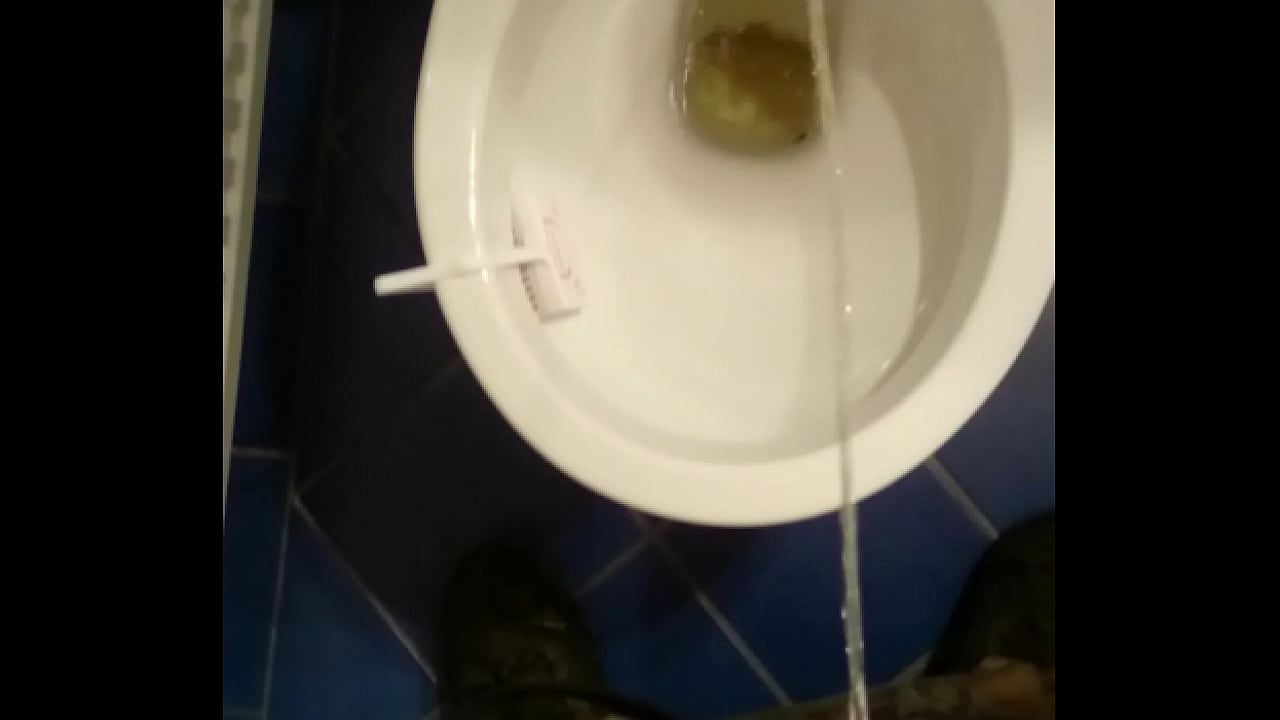 Guy pissing in toilet