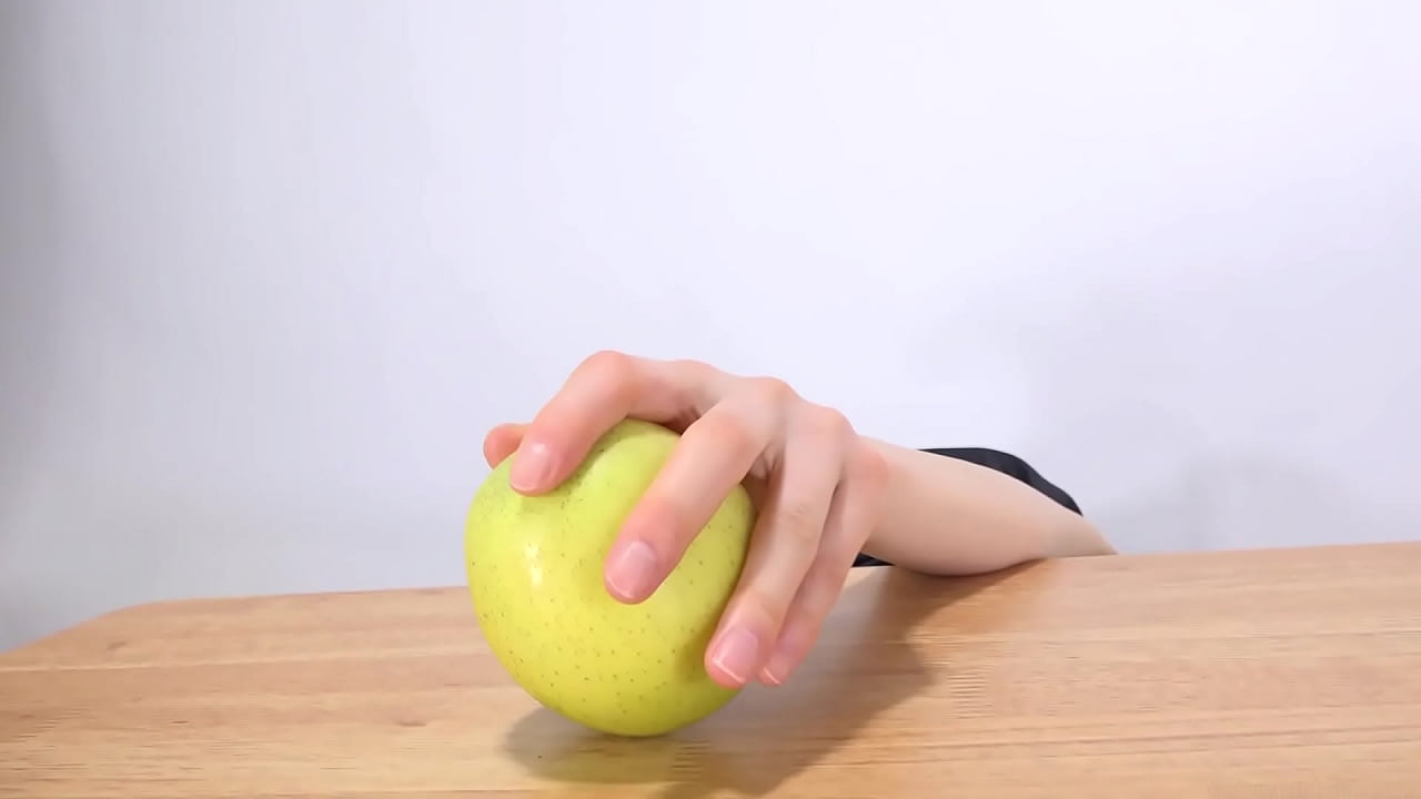 Woman's hand grabs an apple