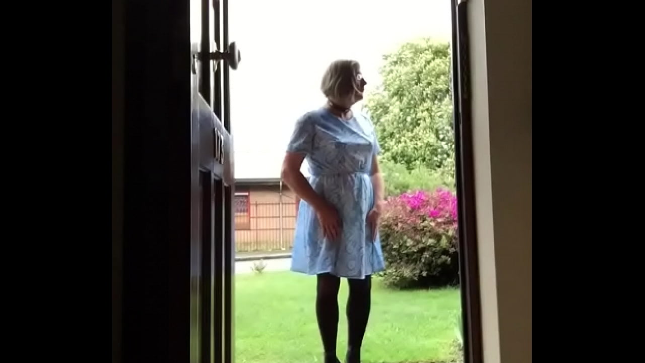 Johanna walks through front door into garden where neighbours could view.