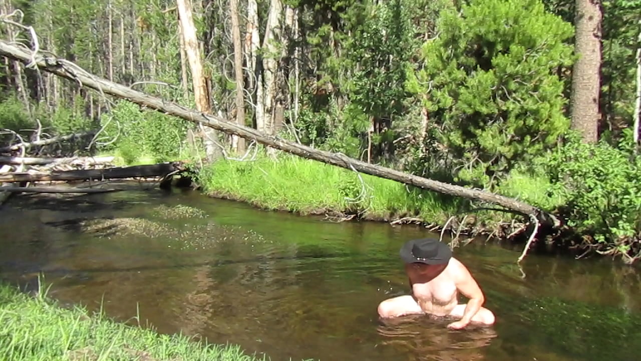 Naked in the stream.