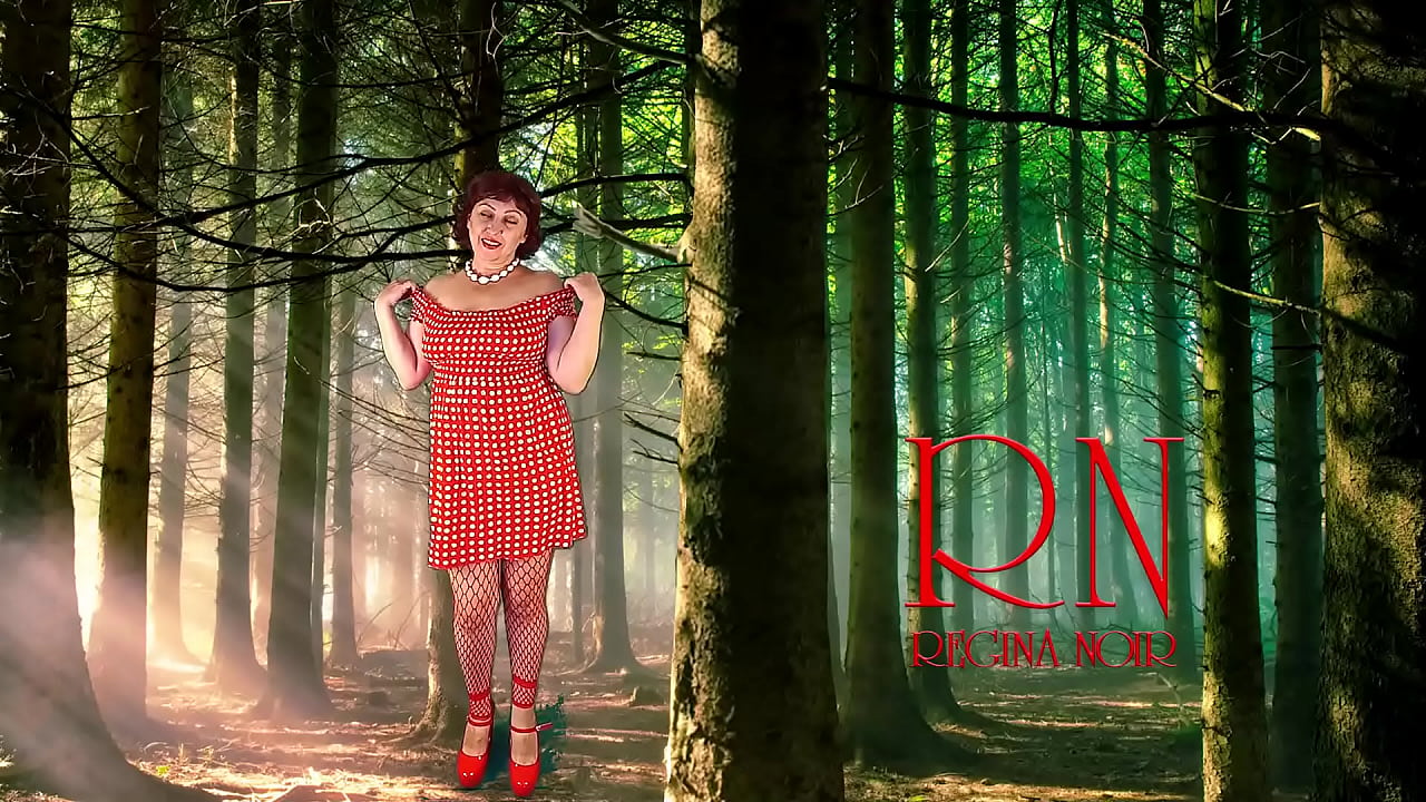 Pin-up lady posing in the forest. She shows her tits and pussy. Mesh tights. Regina Noir