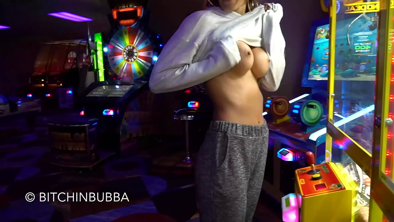 Flashing her boobs in the gaming arcade